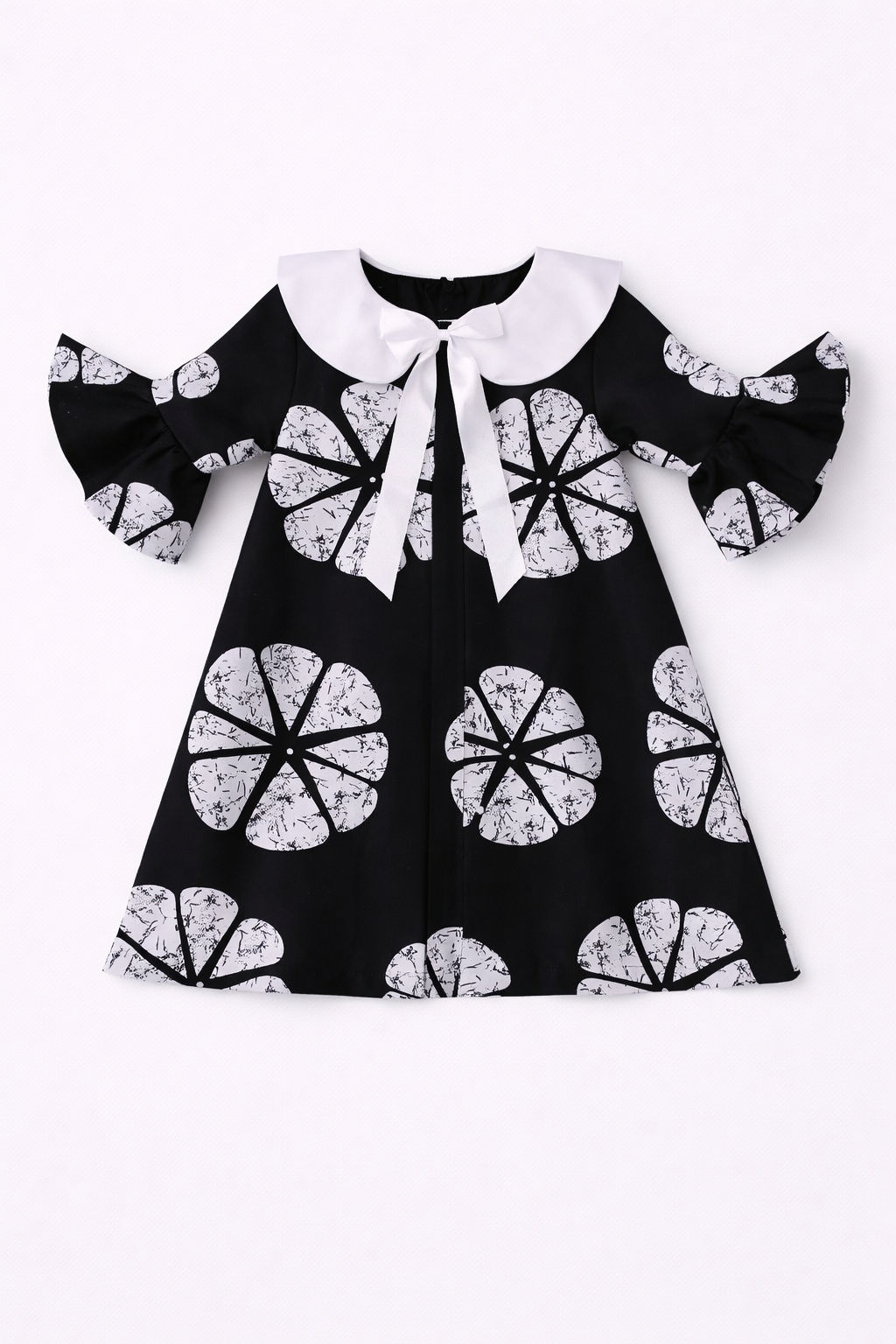 Black dress with white floral patterns on a white background