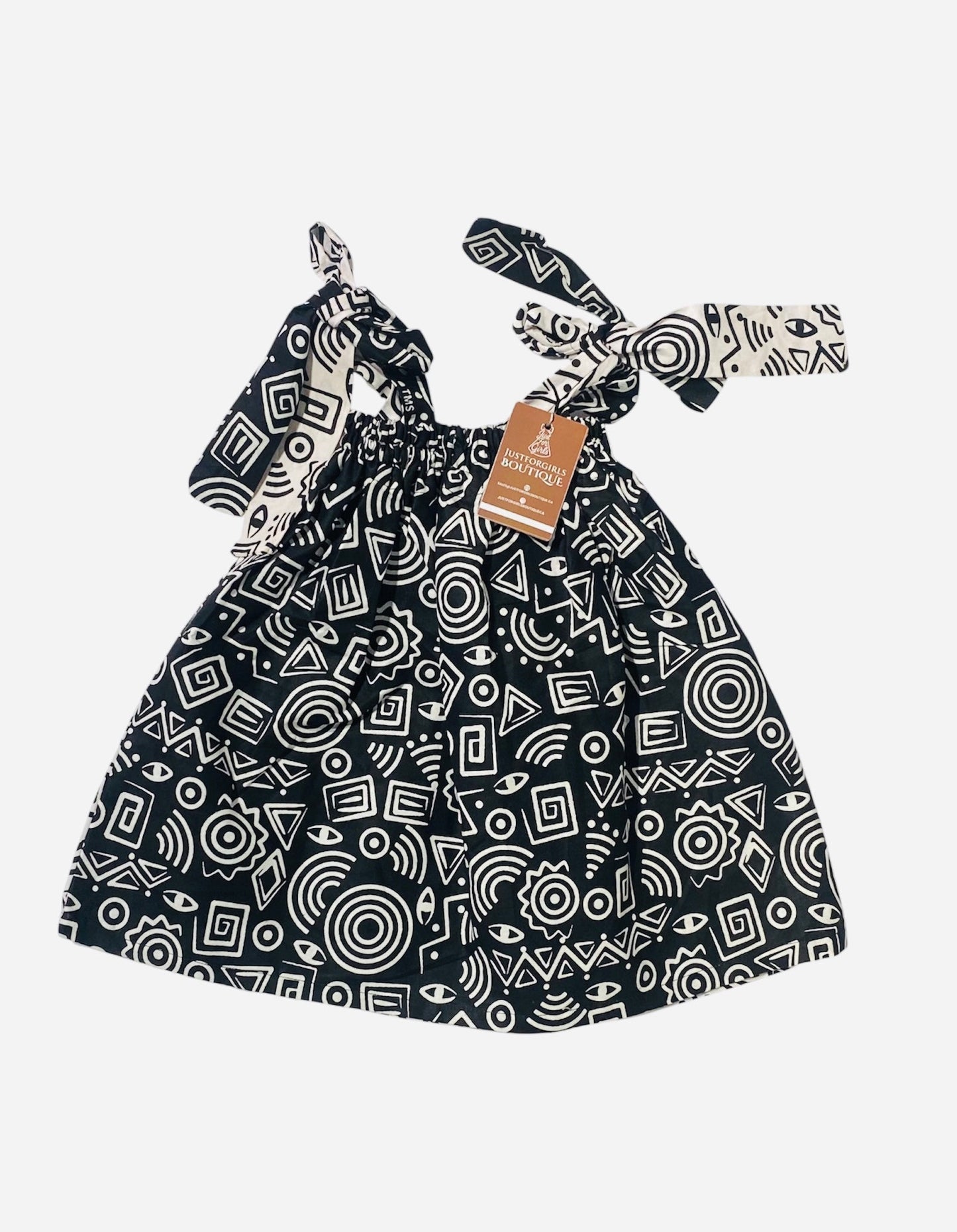 Black and white patterned dress with tiestraps on a white background